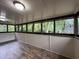Enclosed sunroom with many windows and wood flooring at 420 Creekview Ct, Marietta, GA 30064