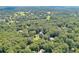 Lush neighborhood aerial view highlights the mature trees around this home at 575 Valley Hall Dr, Sandy Springs, GA 30350