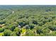 Beautiful aerial perspective of house nestled among mature trees in a private location at 575 Valley Hall Dr, Sandy Springs, GA 30350