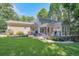 Expansive backyard featuring a brick patio and lush landscaping, perfect for outdoor enjoyment at 575 Valley Hall Dr, Sandy Springs, GA 30350
