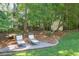Serene backyard retreat with comfortable lounge chairs nestled on a stone patio, perfect for relaxing outdoors at 575 Valley Hall Dr, Sandy Springs, GA 30350