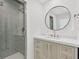 This neutral bathroom boasts a modern shower and a round mirror at 575 Valley Hall Dr, Sandy Springs, GA 30350