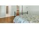 This bedroom boasts hardwood floors, an iron bed frame, and multiple entrances at 575 Valley Hall Dr, Sandy Springs, GA 30350