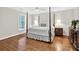 Light-filled bedroom featuring hardwood floors and a four poster bed at 575 Valley Hall Dr, Sandy Springs, GA 30350