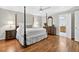 Spacious bedroom with hardwood floors and views into an attached bathroom at 575 Valley Hall Dr, Sandy Springs, GA 30350