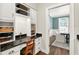 Butler's pantry with granite counters, custom cabinets, and built in desk at 575 Valley Hall Dr, Sandy Springs, GA 30350