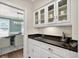 Butler's pantry with granite counters and glass front cabinets at 575 Valley Hall Dr, Sandy Springs, GA 30350