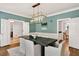Dining room with modern chandelier, wainscoting and hardwood floors at 575 Valley Hall Dr, Sandy Springs, GA 30350