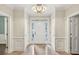 Elegant foyer with marble flooring, custom trim, and a stunning light fixture, creating a grand entrance at 575 Valley Hall Dr, Sandy Springs, GA 30350