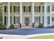 Detailed view of home's entrance featuring classic columns and black shutters and flower planter decoration at 575 Valley Hall Dr, Sandy Springs, GA 30350