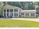 Lovely exterior view of home with symmetrical facade and well-manicured lawn at 575 Valley Hall Dr, Sandy Springs, GA 30350