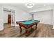 The game room features a billiard table, wood floors, and natural light at 575 Valley Hall Dr, Sandy Springs, GA 30350