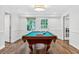 Spacious game room features a billiard table, wood floors, and ample natural light at 575 Valley Hall Dr, Sandy Springs, GA 30350