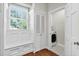 Well-lit hallway with a bench, storage, and access to a laundry room at 575 Valley Hall Dr, Sandy Springs, GA 30350