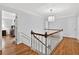 Upstairs hallway featuring hardwood floors and decorative trim at 575 Valley Hall Dr, Sandy Springs, GA 30350