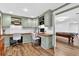 Bright home office with built-in cabinets, wood floors, and view to game room at 575 Valley Hall Dr, Sandy Springs, GA 30350