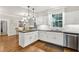Well-lit kitchen with white cabinets, stainless steel appliances, and an adjacent dining area at 575 Valley Hall Dr, Sandy Springs, GA 30350