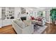 Bright living room featuring a fireplace, built-in shelving, and hardwood floors at 575 Valley Hall Dr, Sandy Springs, GA 30350