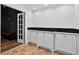 This living room features white cabinets, black countertops, and access to another room at 575 Valley Hall Dr, Sandy Springs, GA 30350