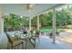 Covered porch with ceiling fan, ideal for entertaining, and features outdoor dining and lounge spaces at 575 Valley Hall Dr, Sandy Springs, GA 30350