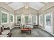 Inviting sunroom with ample natural light, vaulted ceiling, and tile floors at 575 Valley Hall Dr, Sandy Springs, GA 30350