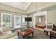 Relaxing sunroom with a vaulted ceiling, tiled floors, and comfortable seating at 575 Valley Hall Dr, Sandy Springs, GA 30350