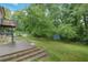 Enjoy the serene backyard with a patio, grassy area, and storage shed at 2142 Troutdale Dr, Decatur, GA 30032