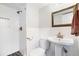Bright bathroom featuring a white pedestal sink, a toilet, and a glass-enclosed shower with tile surround at 2142 Troutdale Dr, Decatur, GA 30032