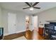 Bedroom featuring hardwood floors, a ceiling fan, and doorway view into the bathroom at 2142 Troutdale Dr, Decatur, GA 30032