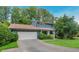 Charming blue home featuring a well-maintained front lawn, mature trees, and a two-car garage at 2142 Troutdale Dr, Decatur, GA 30032