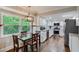 Bright kitchen with white cabinets, stainless steel appliances, and dining area with backyard view at 2142 Troutdale Dr, Decatur, GA 30032