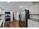 Modern kitchen featuring stainless steel appliances, granite countertops, and hardwood floors at 2142 Troutdale Dr, Decatur, GA 30032