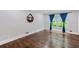 Bright living room with hardwood floors, large window with blue curtains, and decorative shelving at 2142 Troutdale Dr, Decatur, GA 30032