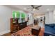 Open living room featuring hardwood floors, ceiling fan, and seamless transition to the kitchen at 2142 Troutdale Dr, Decatur, GA 30032