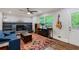 Cozy living room features a fireplace, built-in shelving, a ceiling fan, and a bright window at 2142 Troutdale Dr, Decatur, GA 30032