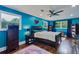 Large bedroom with hardwood floors, windows, ceiling fan, and blue walls at 2142 Troutdale Dr, Decatur, GA 30032