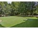 Expansive backyard with mature trees surrounding a well-maintained green lawn at 2671 Bohler Nw Rd, Atlanta, GA 30327