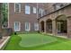 Backyard with a putting green, brick architecture, and an outdoor covered patio area at 2671 Bohler Nw Rd, Atlanta, GA 30327