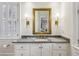 Elegant bathroom featuring a vanity with a marble countertop, gold hardware, and a decorative mirror at 2671 Bohler Nw Rd, Atlanta, GA 30327