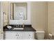 Elegant bathroom featuring a black countertop, white cabinets, and stylish wallpaper at 2671 Bohler Nw Rd, Atlanta, GA 30327