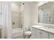 Well-lit bathroom featuring a tub with shower, a vanity with a marble countertop, and tile flooring at 2671 Bohler Nw Rd, Atlanta, GA 30327