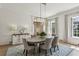 Bright dining room featuring wainscoting, hardwood floors, and a modern chandelier at 2671 Bohler Nw Rd, Atlanta, GA 30327