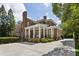 Elegant brick home with white columned porch, manicured landscaping, and circular driveway at 2671 Bohler Nw Rd, Atlanta, GA 30327