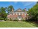 Beautiful brick two-story home featuring a manicured lawn and mature landscaping at 2671 Bohler Nw Rd, Atlanta, GA 30327