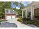 Traditional brick home with a detached garage, mature landscaping, and a welcoming front porch at 2671 Bohler Nw Rd, Atlanta, GA 30327