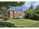 Classic brick home with lush landscaping, showcasing timeless elegance and curb appeal at 2671 Bohler Nw Rd, Atlanta, GA 30327
