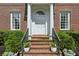 Inviting front entrance with brick steps, white columns, and manicured greenery at 2671 Bohler Nw Rd, Atlanta, GA 30327