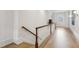 Bright hallway with hardwood floors, a staircase, and wall sconces at 2671 Bohler Nw Rd, Atlanta, GA 30327