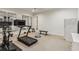 Well-equipped home gym with treadmill, exercise bike, weight training equipment, and mirrored wall at 2671 Bohler Nw Rd, Atlanta, GA 30327