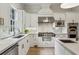 Well-appointed kitchen featuring an island with prep sink, stone countertops, and stainless appliances at 2671 Bohler Nw Rd, Atlanta, GA 30327